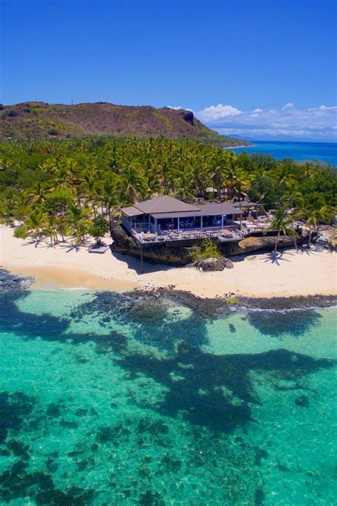 an aerial view of a tropical island with a restaurant on the beach and ...