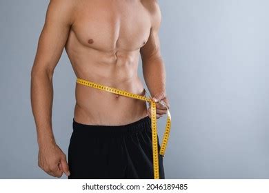 Shirtless Man Slim Body Measuring Tape Stock Photo