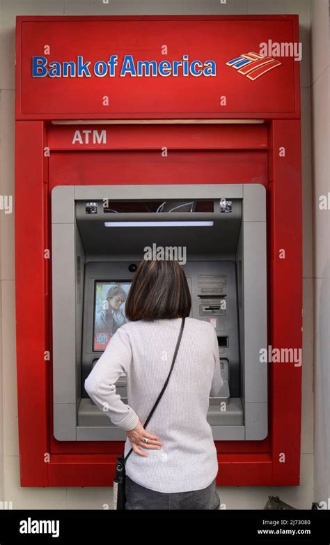 A Woman Makes A Cash Withdrawal From A Bank Of America ATM Machine In