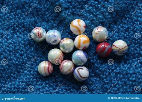 Marbles Colourful In Group On Blue Fabric Background Landscape Format