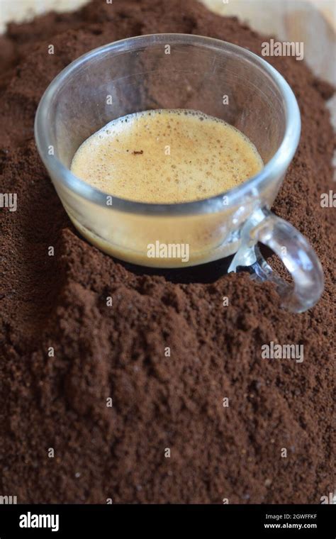 Restricted Espresso Dipped In Ground Coffee Stock Photo Alamy