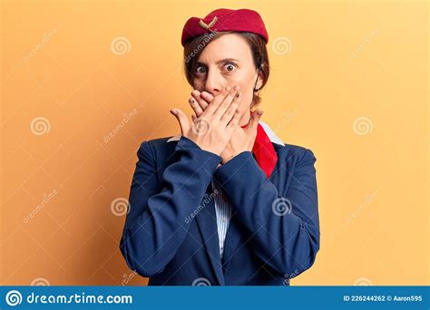 Young Beautiful Woman Wearing Stewardess Uniform Shocked Covering Mouth With Hands For Mistake