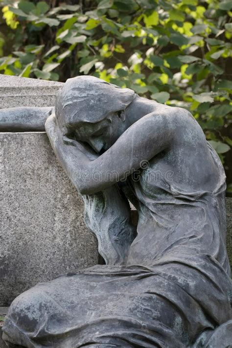 Sculpture Of A Young Grieving Woman Broken Down Next To A Stone Made