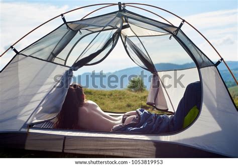 Back View Of Attractive Naked Female Traveller Lying In Tent In