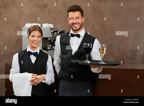 Waiter and waitress serving drinks in a hotel restaurant Stock Photo ...