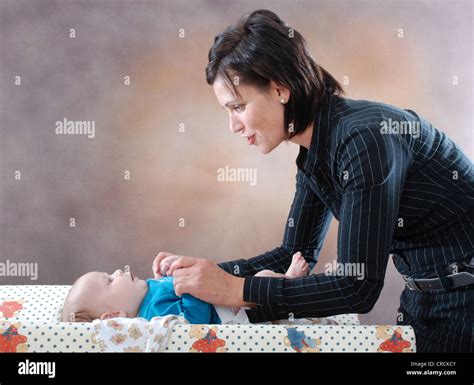 Two Women Changing Diaper Hi Res Stock Photography And Images Alamy