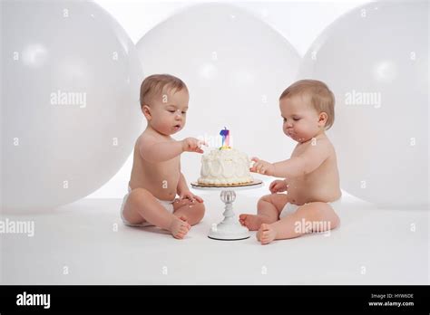One Year Old Twin Brothers Wearing Diapers And Eating Their Birthday