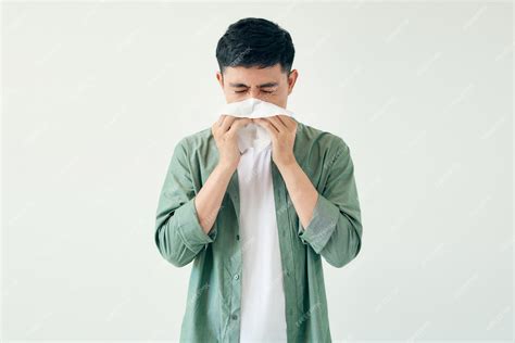 Premium Photo Young Man Wiping His Nose With A Tissue On White Background