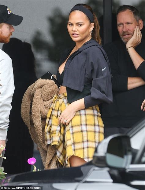 Chrissy Teigen Shows Off Her Toned Legs While Wearing A Flannel Over