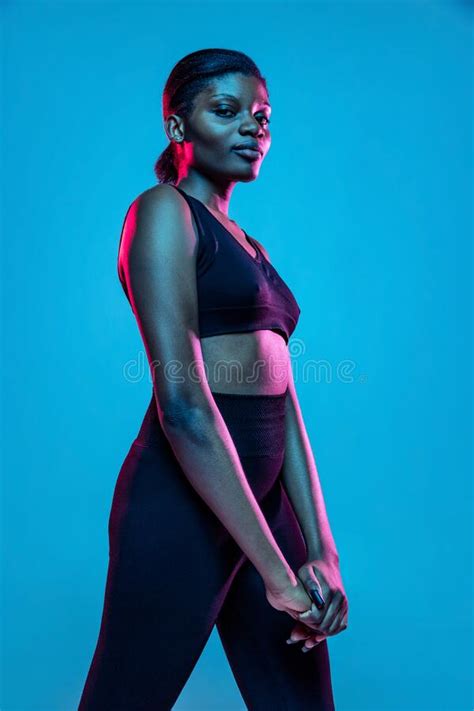 Portrait Of Young Beautiful Dark Skinned Woman Posing Isolated On Blue