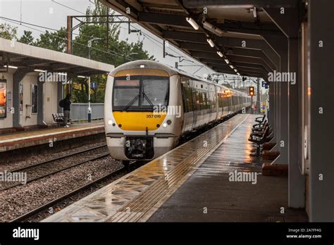 C2c Train Pulling Into Basildon Station Essex Uk Class 357 Electrostar Emu In Heavy Rain Wet