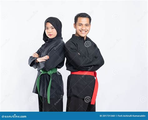 Asian Men And Women Wearing Pencak Silat Uniforms Stand Back To Back