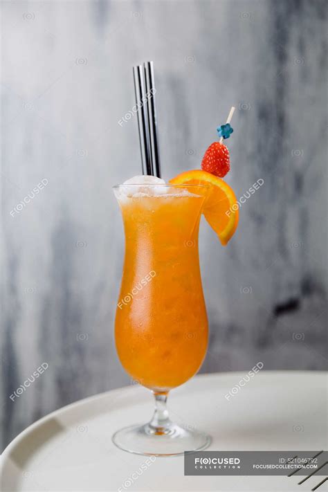 Glass Of Cold Sex On Beach Cocktail Containing Vodka Peach Liqueur Orange Juice With Straw And