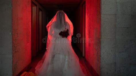 Ghostly Figure Of Woman In Wedding Dress Walking Along A Creepy Hotel