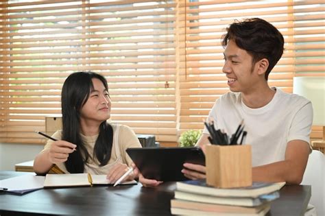 Premium Photo Smiling Older Brother Explaining Homework Assignment