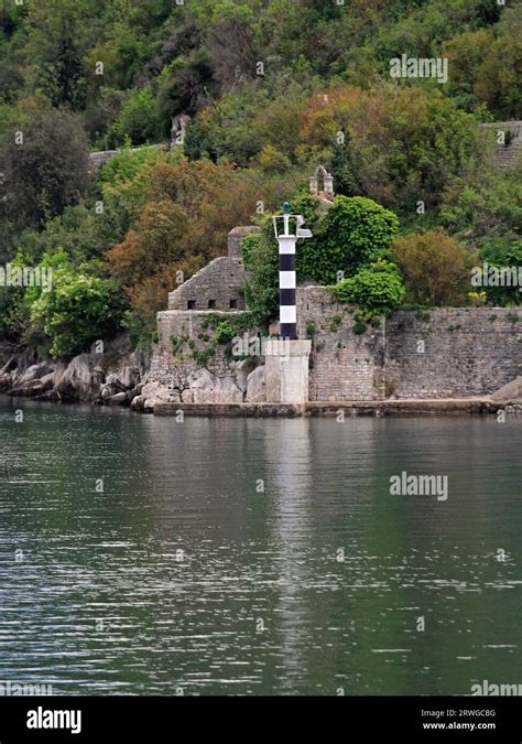 Black And White Lighthouse Pillar At Entrance To Boka Kotorska Bay In