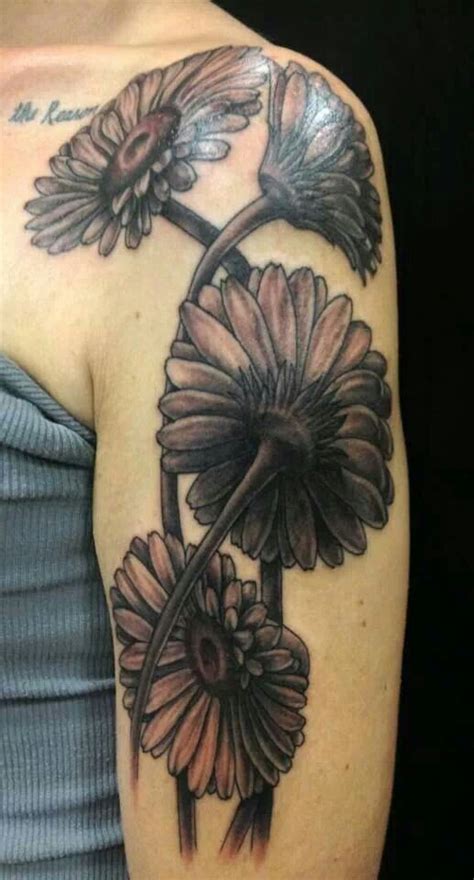 Realistic Black And White Daisy Flowers Tattoo On Upper Arm