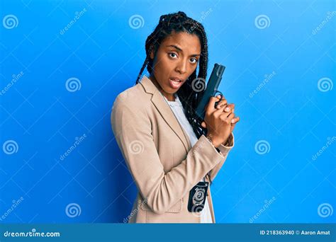 African American Police Woman Holding Gun In Shock Face Looking