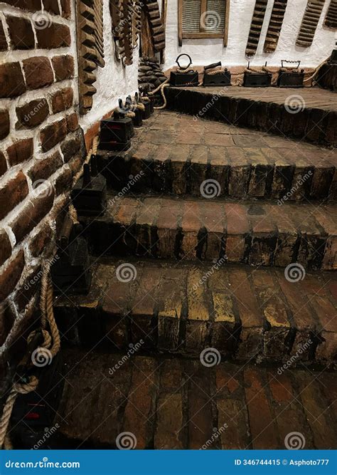 Vintage Brick Staircase with Antique Irons on Display Stock Image