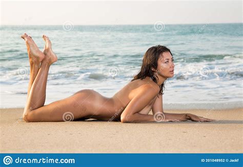 Naked Woman Playfully Lying On The Sand On The Sea Stock Photo Image Of Cheerful Positive