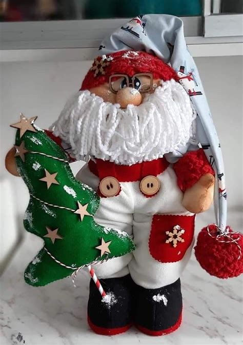 A Santa Clause Figurine Holding A Christmas Tree