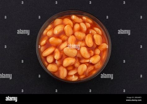 Baked Beans In Tomato Sauce On Black Background Top View Stock Photo