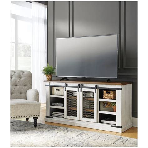 A Large Flat Screen Tv Sitting On Top Of A Wooden Entertainment Center