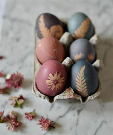 An Egg Carton Filled With Painted Eggs Sitting On Top Of A Marble