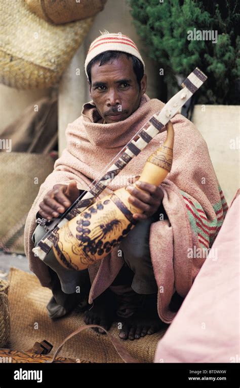 A local man with a traditional instrument made with a calabash in the ...