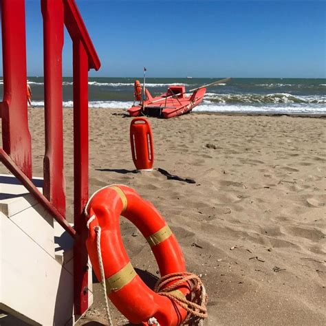 Premium Photo Red Deck Chairs On Beach Against Sky