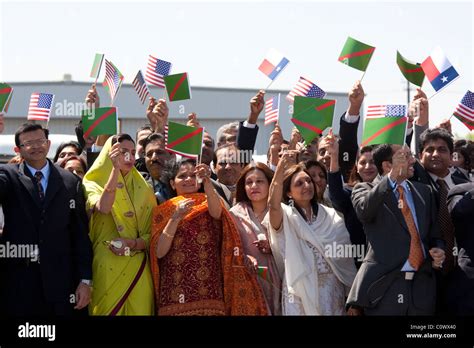 Ismaili Muslims wave small Ismaili and Texas flags while greeting the ...