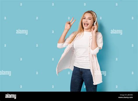 Blonde Girl With Orthodontic Braces Listens To The Music And Enjoys It Stock Photo Alamy