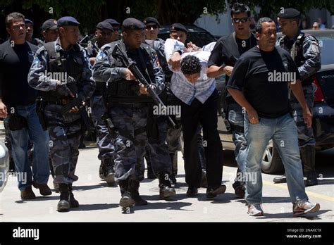 Antonio Bonfim Lopes Alias Nem Walks Bent Forward As He Is Escorted