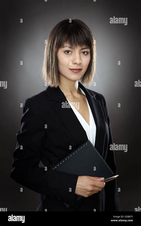 Professional Looking Business Woman Holding A Notebook And Pen Stock