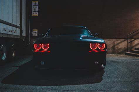 Black car with red headlights in night · Free Stock Photo