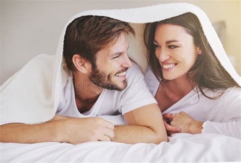 Happy Love And Couple In Conversation With Blanket For Relaxing