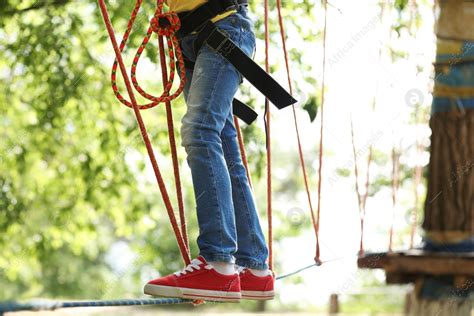 Little Girl Climbing In Adventure Park Summer Camp Stock Photo