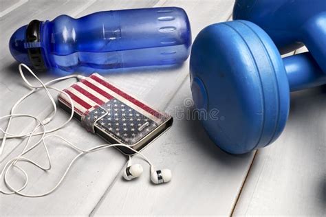 Dumbbells Plastic Bottle Of Water And Smartphone With Headphones Stock