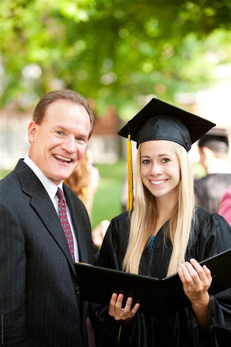 Graduation Father And Daughter Pose For A Snapshot By Stocksy