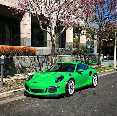 A Green Sports Car Parked On The Side Of The Road