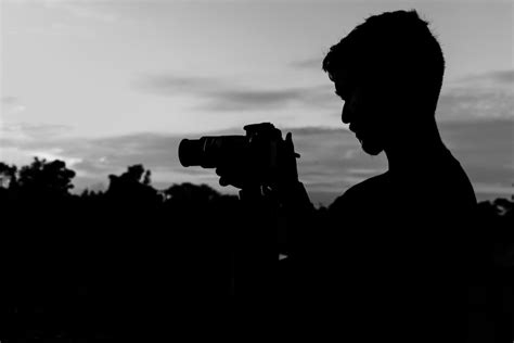 Silhouette of Man Holding Camera · Free Stock Photo