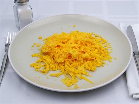 Calories in 1.5 cup(s) of Cheddar Cheese - Shredded.