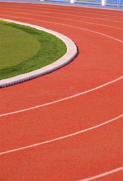 Vertical Background Of Red Synthetic Running Tracks And Green Field In Athletic Outdoors Stadium