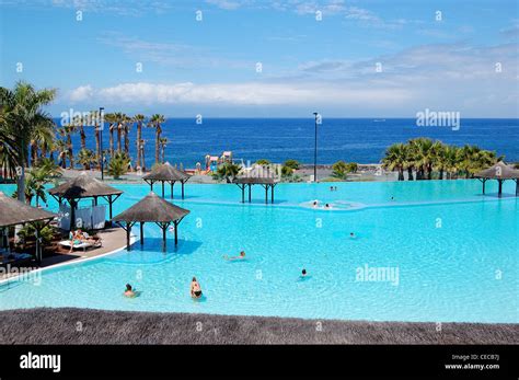 Swimming pool with jacuzzi and beach of luxury hotel, Tenerife island, Spain Stock Photo - Alamy