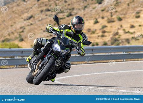 Motorcyclist Driving On The Road While Taking A Sharp Curve With His