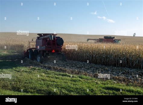 Two Tractors Harvesting American Field Stock Photo Alamy