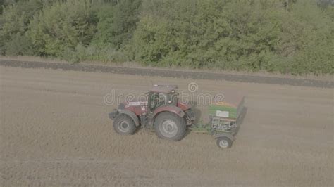 Farmer On Tractor Fertilizing Agricultural Field Spreading Mineral