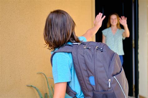 Mother And Son Saying Goodbye On Their Doorstep Boy Going To School