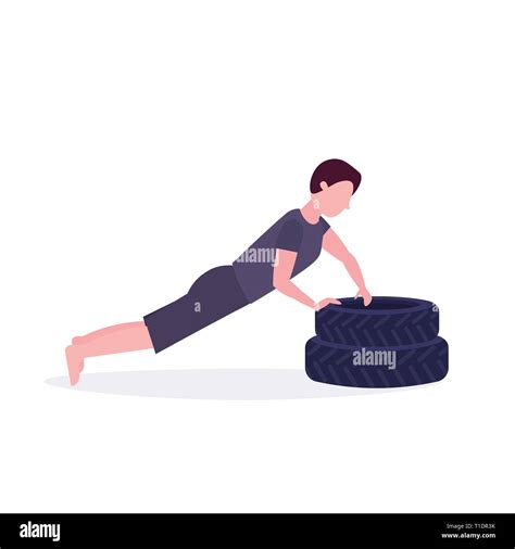 Sports Man Doing Push Up Exercise On Tires Bodybuilder Working Out In