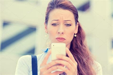 Upset Stressed Woman Holding Cellphone Disgusted With Message She